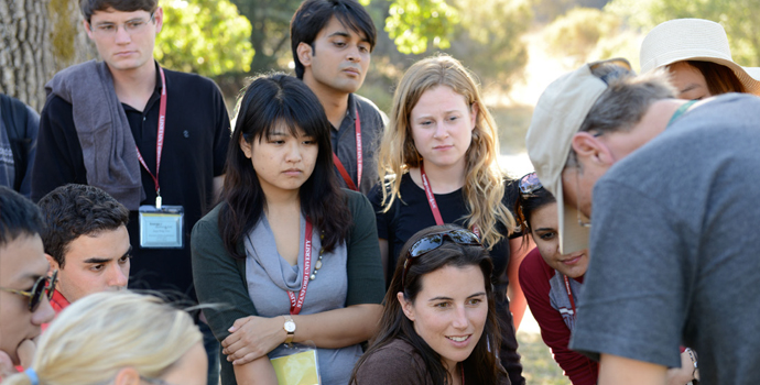 Students looking at professor's demonstration