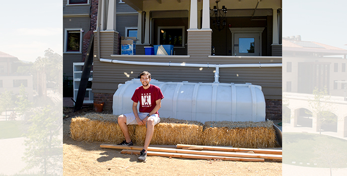 student sitting in front of water catchment system