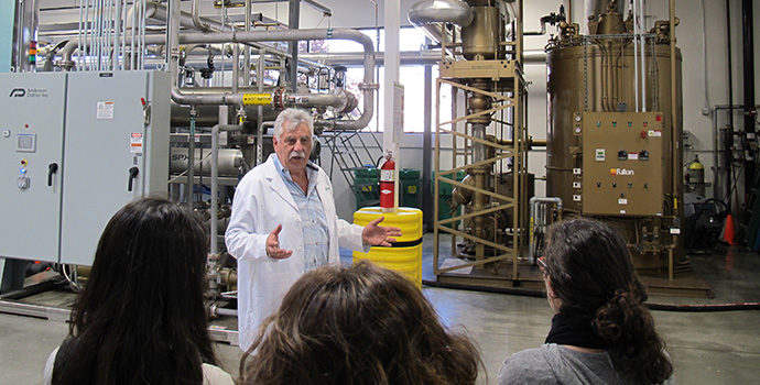 Man in lab coat in front of machine