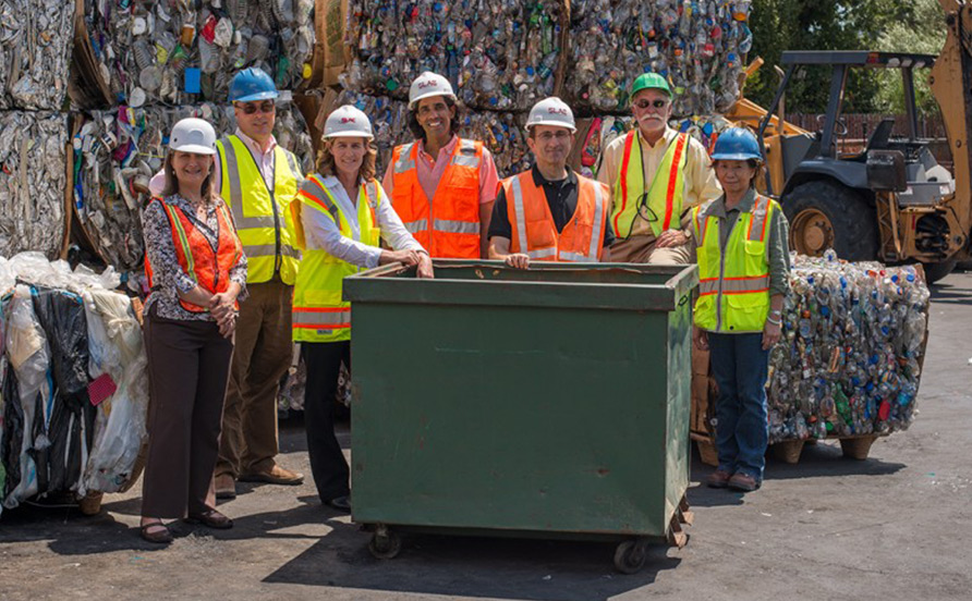 People standing in recycling facility
