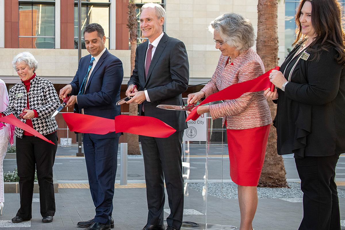 People cutting a ribbon