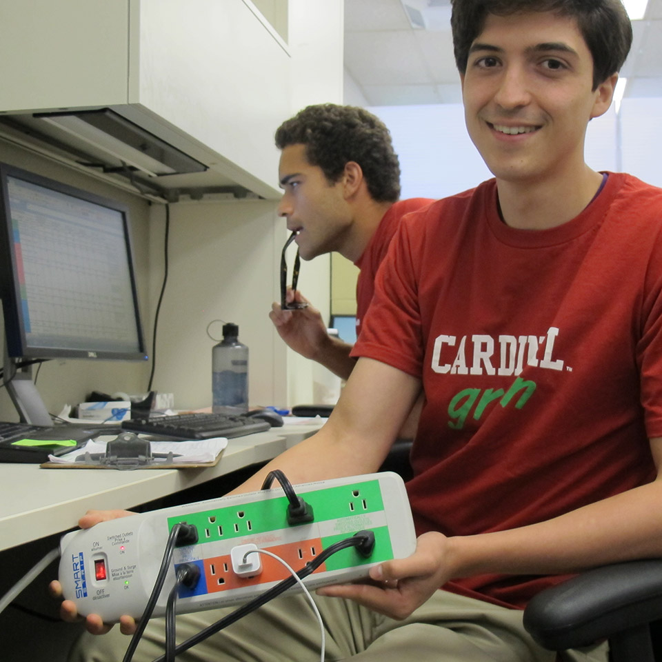 Student showing energy saving power strip