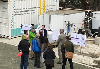 People looking at water treatment equipment